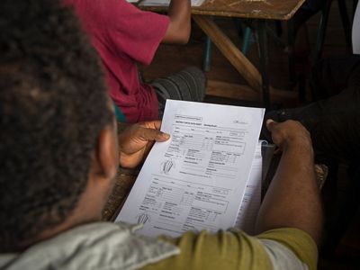 Potential rangers examine a data collection sheet at the training.