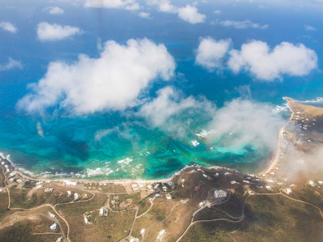 An aerial view of the edge of an island and blue-green water